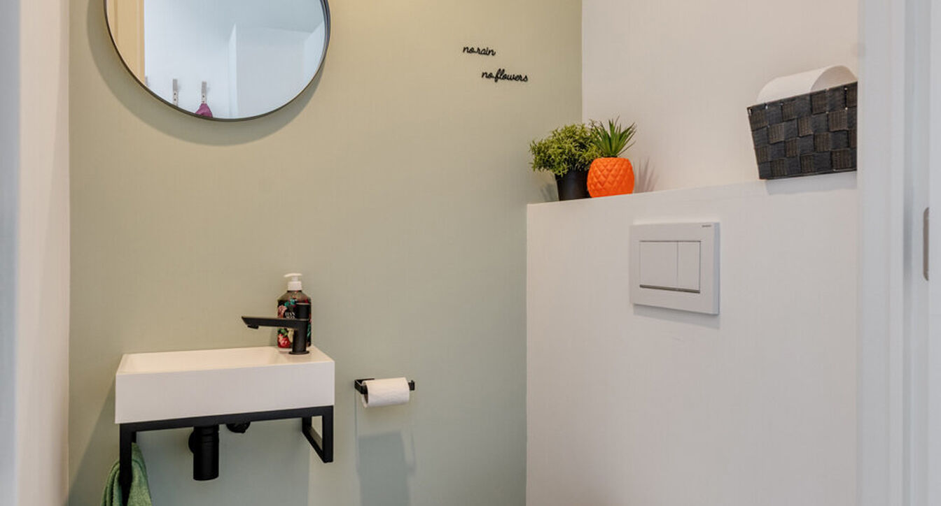 Deze stijlvolle en energiezuinige woning combineert hedendaags wooncomfort met een praktische indeling en een aangename buitenruimte.
Bij het binnenkomen verwelkomt de inkomhal je met een apart gastentoilet. Vervolgens kom je in de ruime leefruimte met o